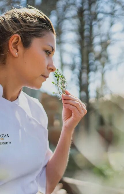Noelia, Terrazas de los Andes Chef, is smelling culinary herbs