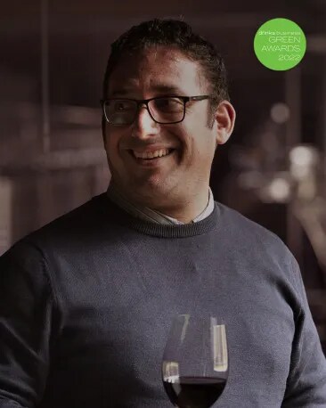 Winemaker orf red malbec wine from argentina smiling with a glass of wine